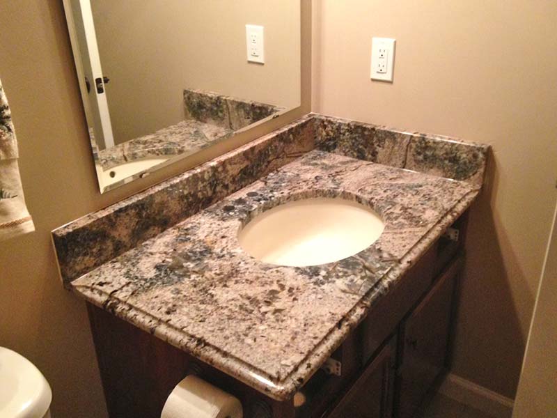 Diamond Wave Granite bathroom counter in a light earth tone bathroom.