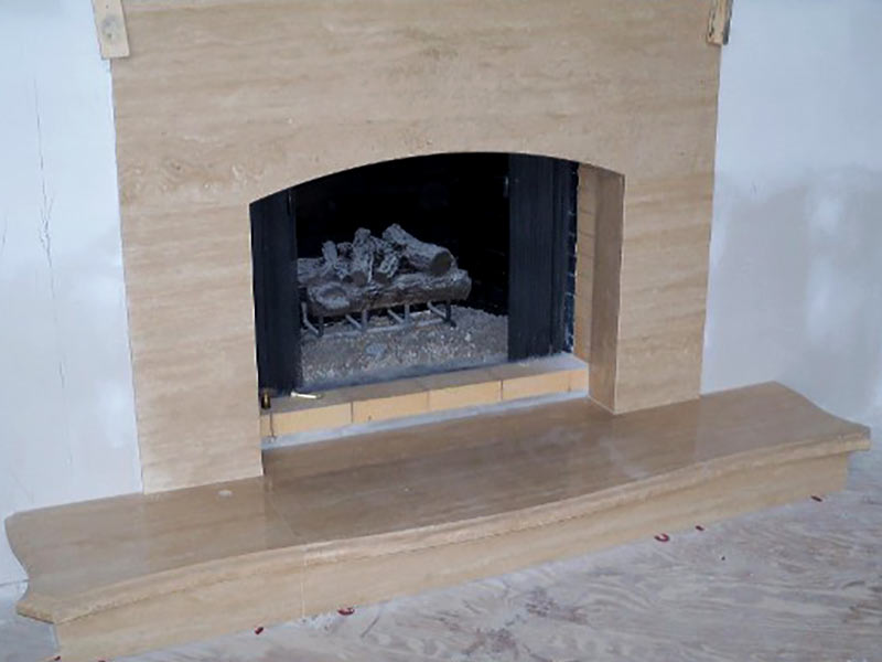 Roman Travertine fireplace surround and hearth.