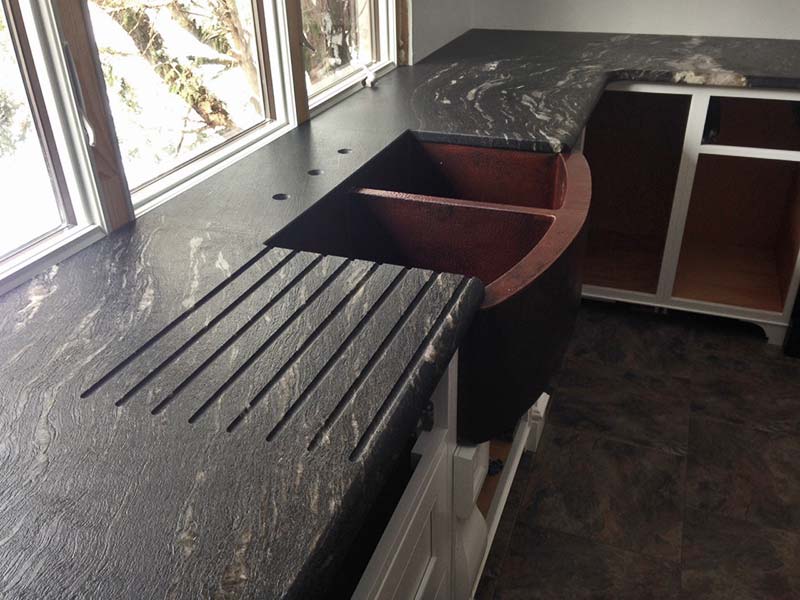 Leathered & Enhanced Black Cosmic Granite kitchen counter with custom drain board.