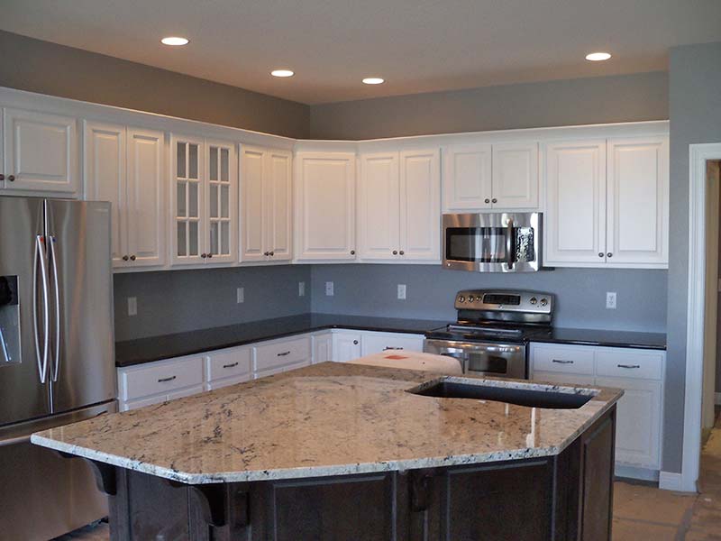 Delicatus Granite over dark wood is the spotlight of this kitchen.