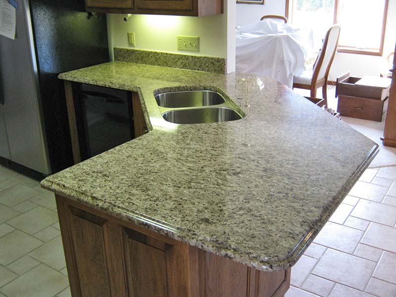 Giallo Ornamental Granite one level peninsula bar for seating.