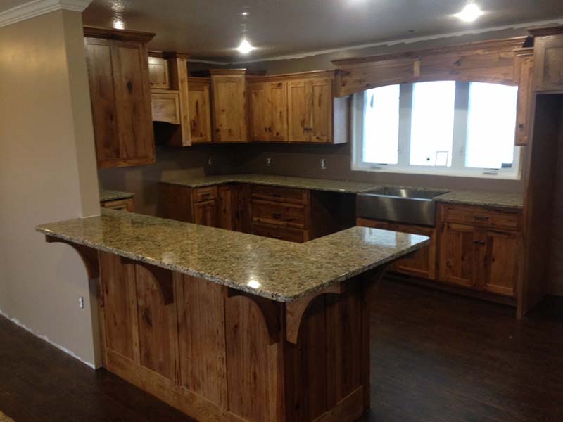 Juperana Gold Granite kitchen island and counters with pine cabinets.