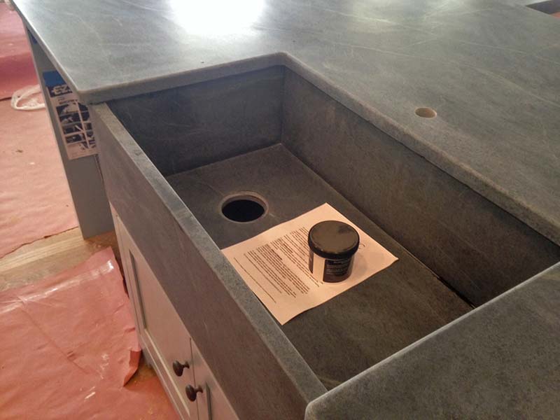 Black soapstone kitchen counter and sink. 