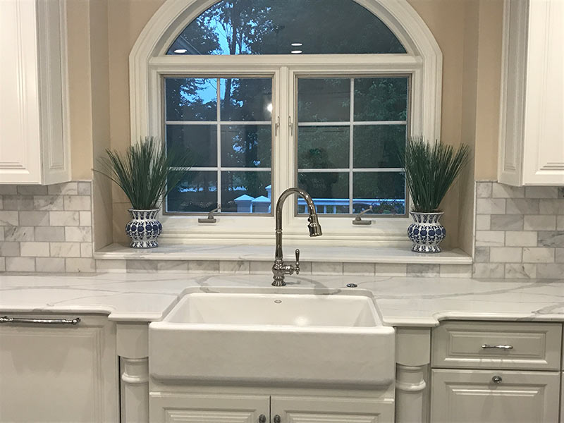 White Quartz with large vein pattern - close up of farmhouse sink and counter tops